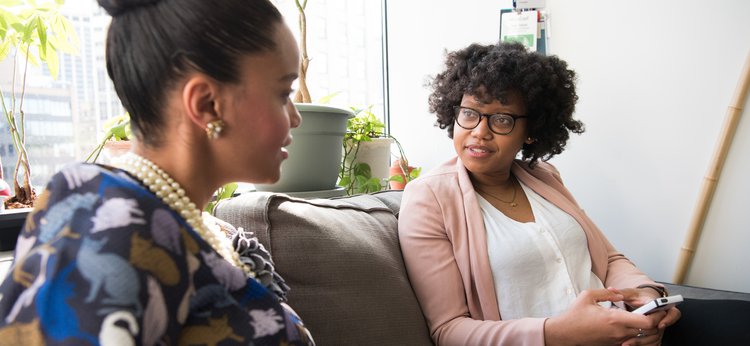 Women having a conversation in an office